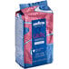 A blue and pink bag of Lavazza Gran Riserva Filtro whole bean coffee on a white background.