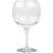 A clear plastic GET Social Club gin and tonic glass with a stem.