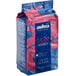 A blue and pink bag of Lavazza Gran Riserva whole bean coffee.