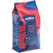 A blue and red bag of Lavazza Top Class whole coffee beans.
