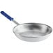 A silver Vollrath aluminum frying pan with a blue handle.
