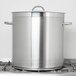 A Vollrath stainless steel domed cover on a large silver pot.