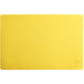 A yellow rectangular cutting board with a white border.