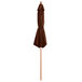A brown umbrella on a wooden pole.