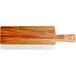 An Acacia wood serving board with a white and brown handle.