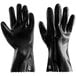 A pair of black rubber gloves with a white background.