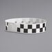 A black and white checkered Carnival King wristband.