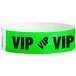 A green paper wristband with black text that reads "VIP"