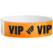 An orange Tyvek wristband with black text that reads "VIP"