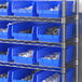 A metal shelving unit with blue Regency shelf bins.