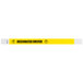 A yellow and white striped Tyvek wristband with black text that says "DESIGNATED DRIVER"