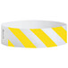 A yellow and white striped paper wristband with black text.