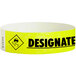 A yellow Carnival King paper wristband with black text that reads "DESIGNATED DRIVER"