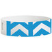 A white wristband with blue chevron arrows and rectangles.