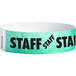 A white Carnival King Tyvek wristband with a blue staff star.