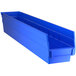 A blue Regency plastic shelf bin with two compartments.