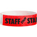 A red Tyvek wristband with black "STAFF" lettering.