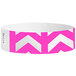 A pink and white Tyvek wristband with chevron arrows pointing up.