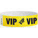 A yellow Carnival King wristband with black "VIP" text.