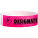 A close-up of a neon pink Carnival King wristband with "DESIGNATED DRIVER" in black text.