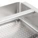 A stainless steel Advance Tabco pre-rinse basket with a welded slide bar over a sink.