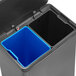 A black Rubbermaid step-on trash can with two blue bins inside.