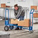 A man using a Lavex 3-in-1 convertible hand truck to move boxes.