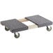 A grey carpeted platform on a Lavex wood dolly with wheels.