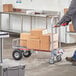 A man using a Lavex hand truck to move boxes.