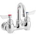 A chrome Waterloo wall mount faucet with silver and red knobs.