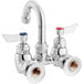 A silver Waterloo wall mount faucet with red knobs and a gooseneck spout.