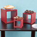 American Metalcraft mahogany wood risers on a table with red boxes of food.