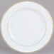 A CAC white porcelain plate with a gold rim.