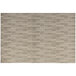 A tan rush woven vinyl rectangular placemat with a patterned design.