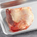 A piece of raw Squab breast on a metal tray.