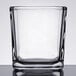 A clear square glass votive holder.