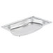 A Vollrath stainless steel kidney-shaped steam table pan with a rounded edge.