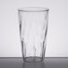 A close-up of a clear Carlisle polycarbonate tumbler with a wavy design.