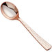 A close-up of a Visions rose gold plastic soup spoon with a silver bowl.