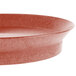 A red oval polypropylene deli server with a metal rim.