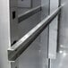 A stainless steel metal shelf rail.