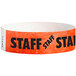 A red and white Carnival King Tyvek wristband with the word "STAFF" in neon red.