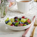 A bowl of fruit in an Acopa Condesa porcelain fruit dish on a table.