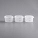 Three white translucent Choice polypropylene food storage containers with lids.