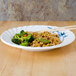 A Blue Bamboo melamine plate with rice and broccoli on it.
