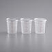 Three clear plastic Choice round food storage containers with lids.