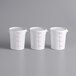 Three white Choice round food storage containers with red markings on the lids.