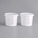 Two white Choice food storage containers with red markings.
