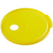 A yellow plastic lid with a white circle on it.