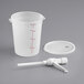 A white plastic container with a spout and a white plastic measuring cup with red lines.